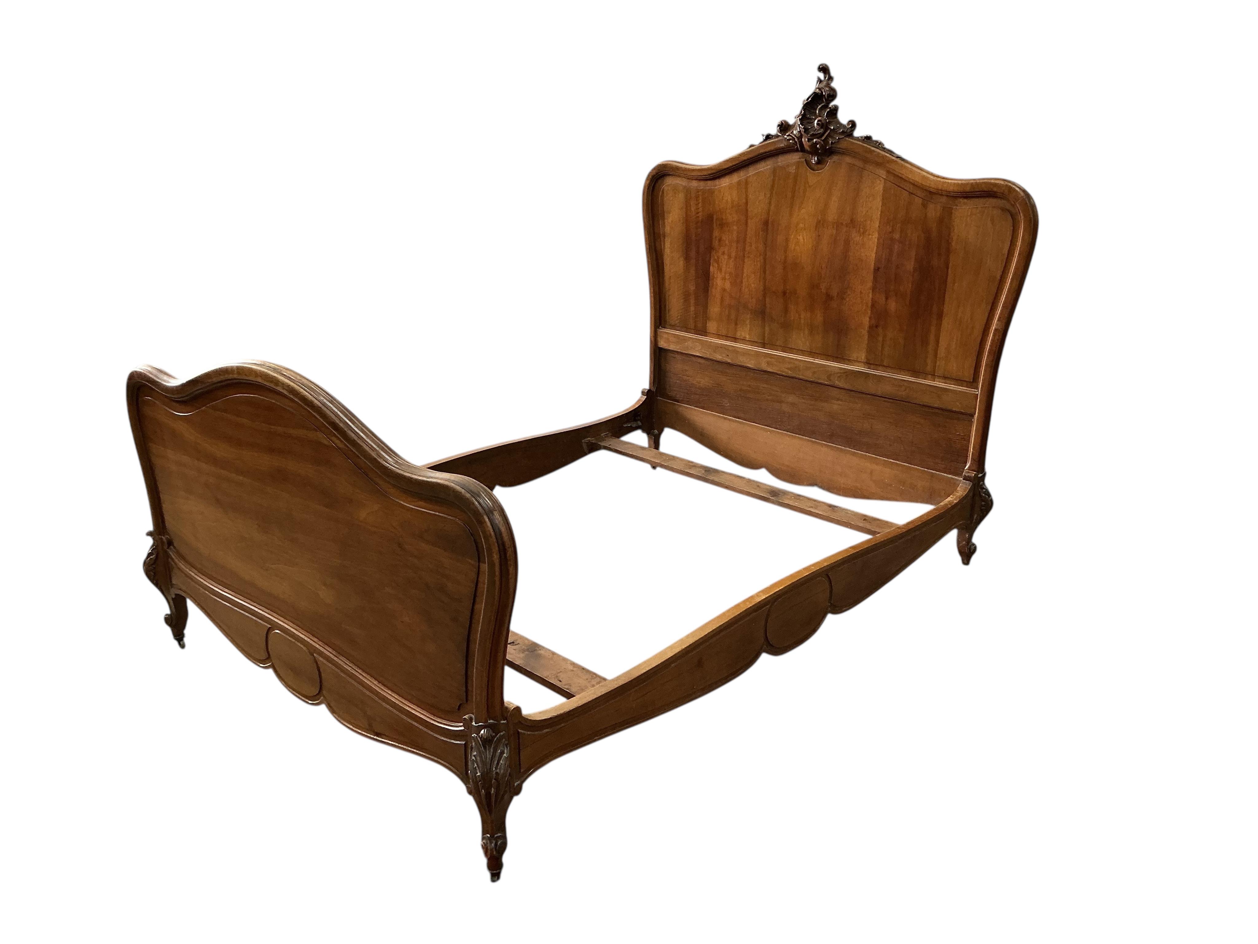 An early 20th century French walnut double bed frame, width 150cm, length 205cm, height 153cm